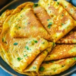 Delicious moon lentil pancakes served with fresh toppings for a nutritious meal.
